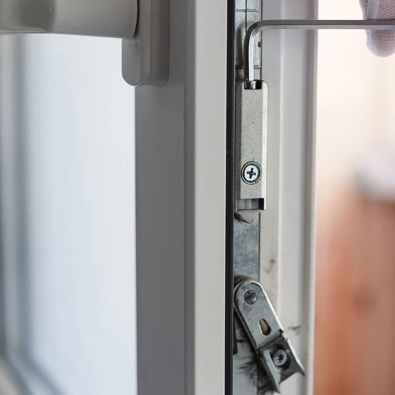 Adjusting the hardware of a uPVC door mechanism with an allen key