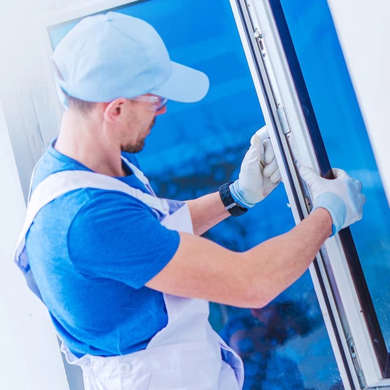 Professional construction worker performing a window replacement